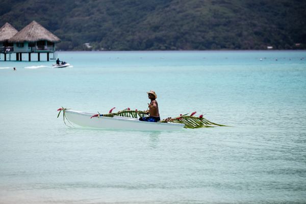 PFBOB Bora Bora person riding on boat near hut Artak Petrosyan.jpg